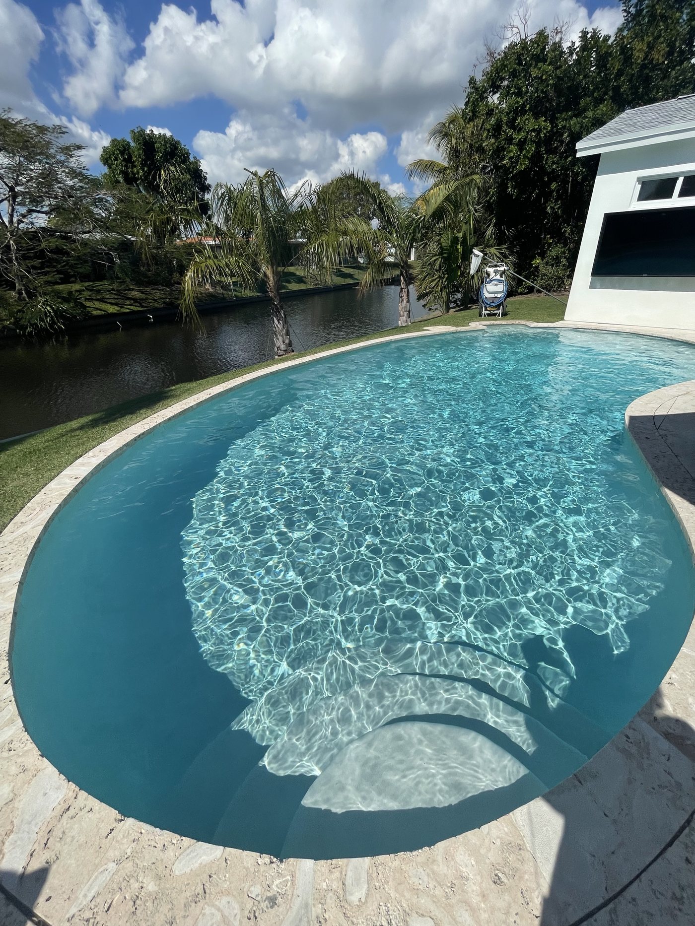 Sparkling waterfront pool maintained by TruBlue Pools of Palm Beach